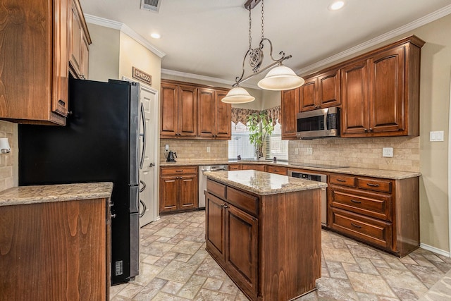 1516 Cheyenne Trl, Mansfield, TX 76063 - kitchen with stainless steel appliances, stone tile floors, crown molding, recessed lighting, and a kitchen island