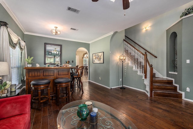 1516 Cheyenne Trl, Mansfield, TX 76063 - living room featuring arched walkways, stairs, a ceiling fan, wood-type flooring, and a dry bar