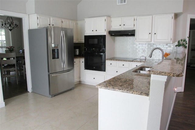6700 Canalview Dr, Arlington, TX 76016 - kitchen with black appliances, under cabinet range hood, a sink, dark stone counters, and a peninsula
