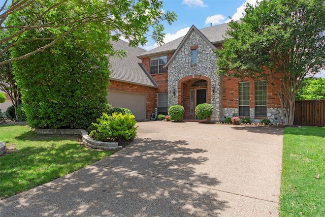 905 Sonora Dr, Allen, TX 75013 - view of front of home featuring driveway, stone siding, an attached garage, brick siding, and a shingled roof