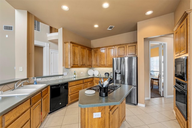 905 Sonora Dr, Allen, TX 75013 - kitchen featuring black appliances, decorative backsplash, light tile patterned flooring, a center island, and recessed lighting
