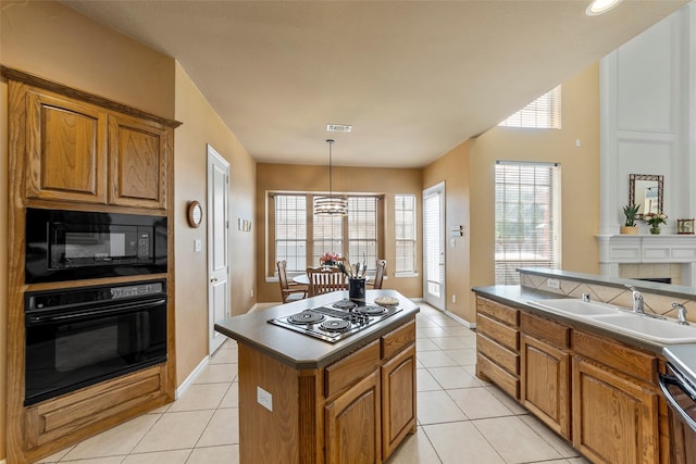 905 Sonora Dr, Allen, TX 75013 - kitchen with black appliances, brown cabinets, and light tile patterned floors
