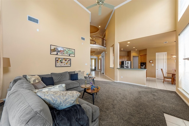 905 Sonora Dr, Allen, TX 75013 - living area featuring a high ceiling, ceiling fan, light tile patterned floors, baseboards, and light carpet