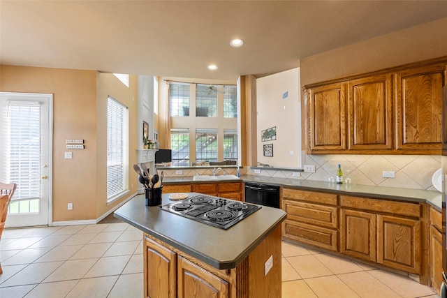 905 Sonora Dr, Allen, TX 75013 - kitchen with black appliances, brown cabinetry, a kitchen island, healthy amount of natural light, and recessed lighting