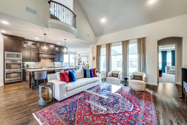 4388 Argyle Ln, Frisco, TX 75034 - kitchen with a chandelier, appliances with stainless steel finishes, dark wood finished floors, dark brown cabinetry, and backsplash