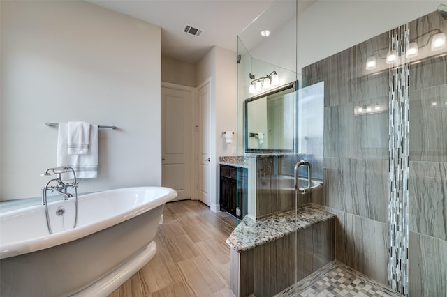4388 Argyle Ln, Frisco, TX 75034 - bathroom featuring a tile shower, a freestanding tub, and vanity