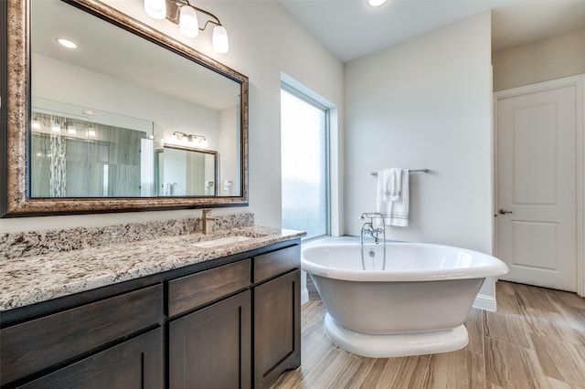 4388 Argyle Ln, Frisco, TX 75034 - bathroom with a soaking tub, vanity, and recessed lighting