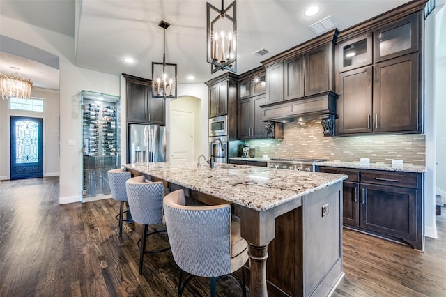 4388 Argyle Ln, Frisco, TX 75034 - kitchen featuring a chandelier, dark wood-style flooring, dark brown cabinetry, stainless steel appliances, and a sink