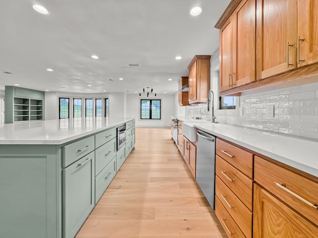 1551 Lower Tonk Valley Rd, Graham, TX 76450 - kitchen with stainless steel dishwasher, recessed lighting, light wood-style flooring, decorative backsplash, and light countertops