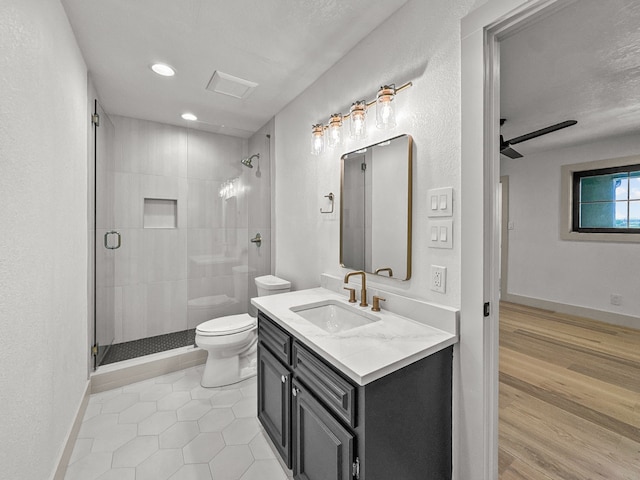 1551 Lower Tonk Valley Rd, Graham, TX 76450 - bathroom featuring toilet, a stall shower, vanity, a ceiling fan, and recessed lighting
