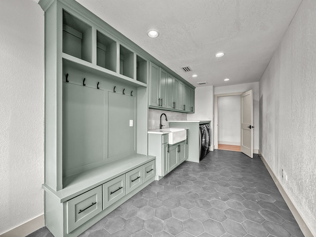 1551 Lower Tonk Valley Rd, Graham, TX 76450 - mudroom featuring a sink, a textured wall, recessed lighting, washer and dryer, and a textured ceiling