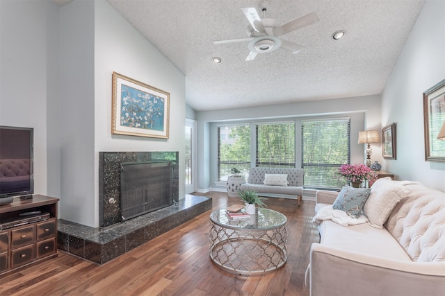 5158 Westgrove Dr, Dallas, TX 75248 - living room featuring a fireplace, wood finished floors, a textured ceiling, a ceiling fan, and vaulted ceiling