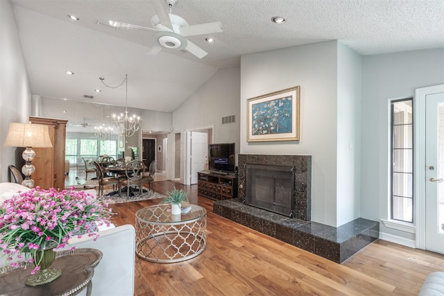 5158 Westgrove Dr, Dallas, TX 75248 - living room with wood finished floors, ceiling fan, a high end fireplace, a chandelier, and high vaulted ceiling