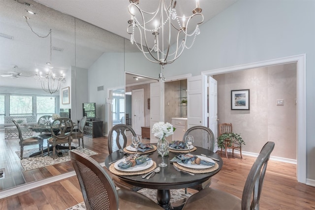 5158 Westgrove Dr, Dallas, TX 75248 - dining area featuring a chandelier, high vaulted ceiling, wood finished floors, a textured ceiling, and baseboards