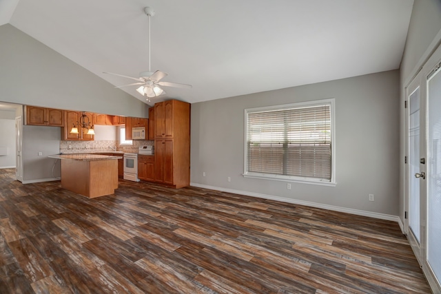 313 W 7th St, Irving, TX 75060 - kitchen with white appliances, a kitchen island, backsplash, dark wood-type flooring, and a ceiling fan