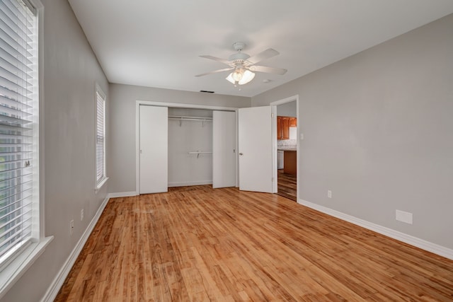 313 W 7th St, Irving, TX 75060 - unfurnished bedroom with light wood-type flooring, multiple windows, baseboards, and a closet