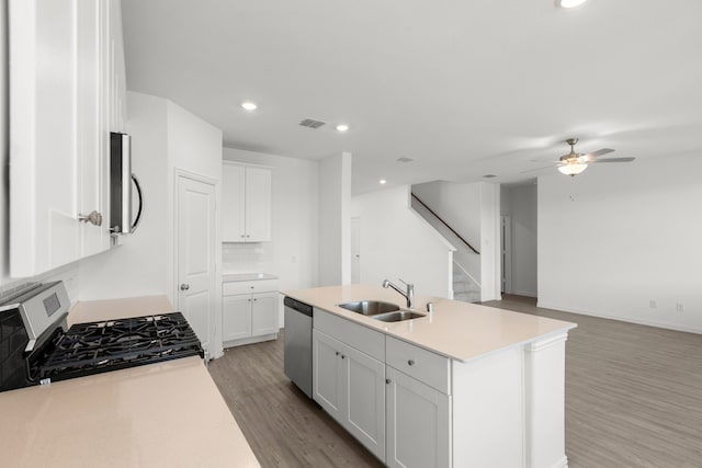 3008 Balmorhea Ln, Mckinney, TX 75071 - kitchen featuring a sink, appliances with stainless steel finishes, light wood-style floors, ceiling fan, and a center island with sink