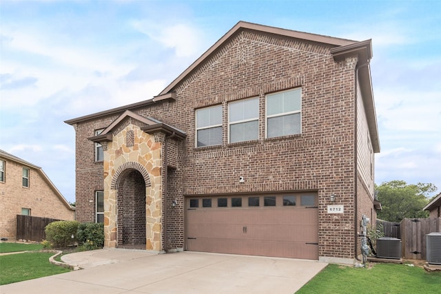 6712 Eliza Dr, Arlington, TX 76001 - view of front facade featuring brick siding, an attached garage, fence, concrete driveway, and central air condition unit