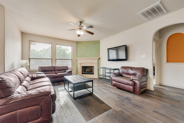 6712 Eliza Dr, Arlington, TX 76001 - living area featuring a ceiling fan, arched walkways, wood finished floors, and a fireplace