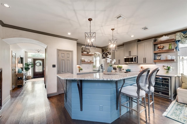 2466 Campfire Ln, Frisco, TX 75033 - kitchen featuring open shelves, appliances with stainless steel finishes, gray cabinetry, wine cooler, and crown molding