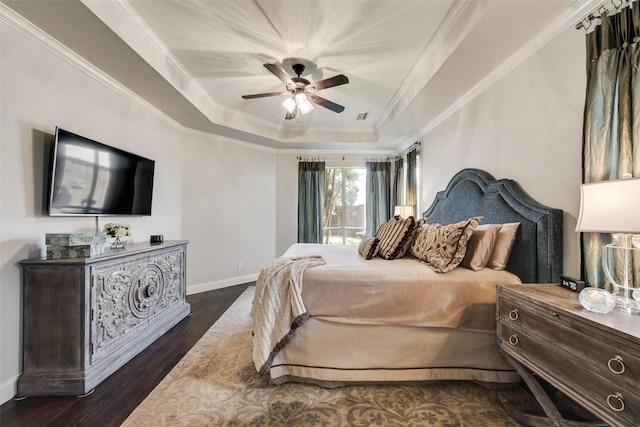2466 Campfire Ln, Frisco, TX 75033 - bedroom featuring a tray ceiling, crown molding, baseboards, dark wood-style flooring, and a ceiling fan