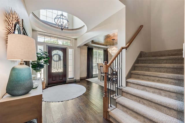 2466 Campfire Ln, Frisco, TX 75033 - entryway with a chandelier, wood finished floors, stairway, and arched walkways