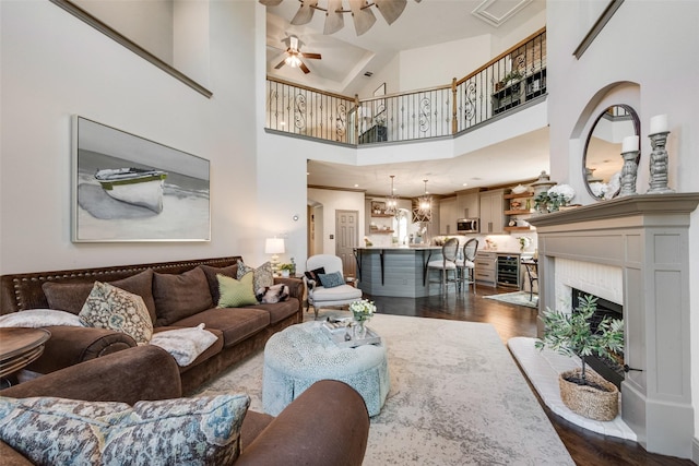 2466 Campfire Ln, Frisco, TX 75033 - living area with ceiling fan, dark wood-style flooring, high vaulted ceiling, and a fireplace with raised hearth