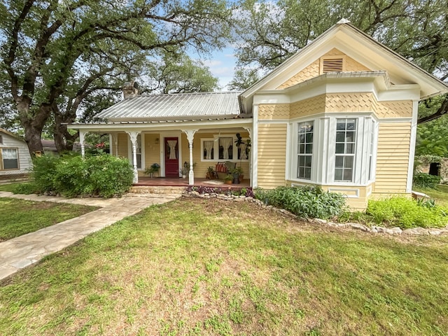 303 E Mclain, Iredell, TX 76649 - victorian-style house featuring a front yard, a porch, and metal roof