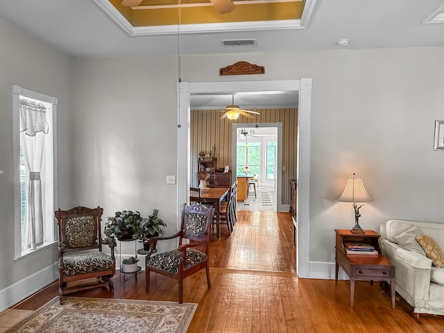 303 E Mclain, Iredell, TX 76649 - living area with a ceiling fan, hardwood / wood-style floors, baseboards, and a raised ceiling