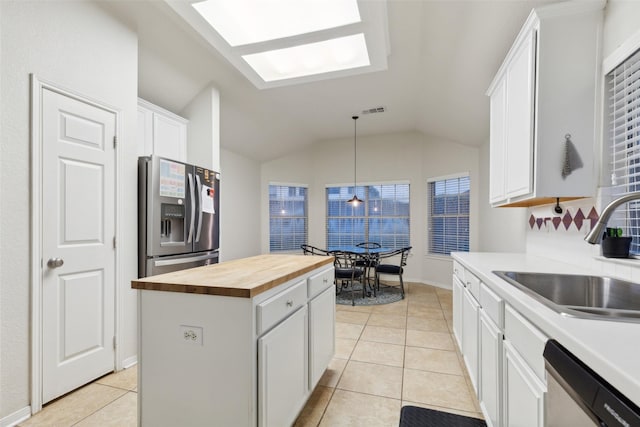 108 Rolling Rock Dr, Trophy Club, TX 76262 - kitchen with wood counters, appliances with stainless steel finishes, a sink, a center island, and vaulted ceiling