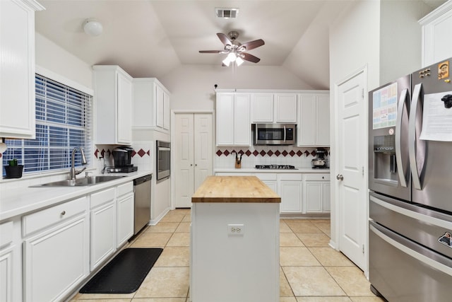 108 Rolling Rock Dr, Trophy Club, TX 76262 - kitchen with stainless steel appliances, a sink, wood counters, a ceiling fan, and backsplash