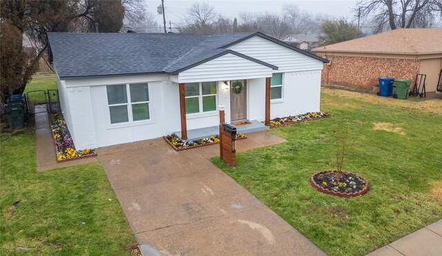1213 Bowie St, Garland, TX 75040 - ranch-style home with a shingled roof, a front lawn, concrete driveway, and brick siding
