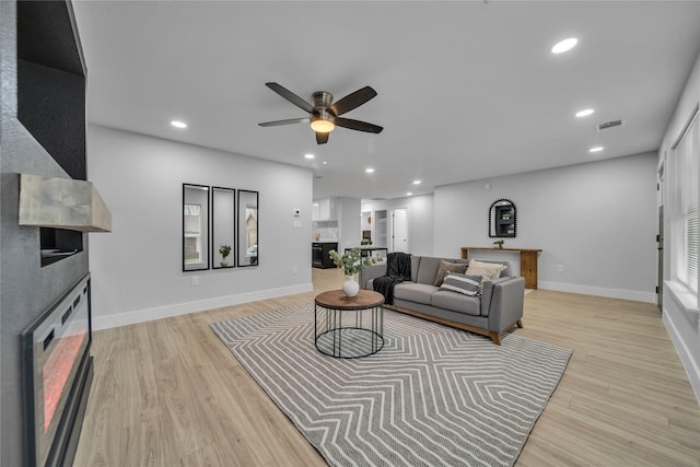 1213 Bowie St, Garland, TX 75040 - living room featuring a fireplace, ceiling fan, light wood-style flooring, recessed lighting, and baseboards