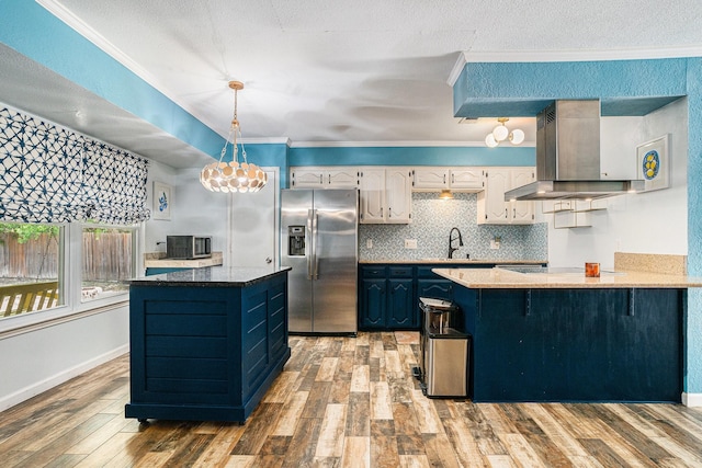 704 Vaughn Dr, Burleson, TX 76028 - kitchen with stainless steel refrigerator with ice dispenser, wall chimney range hood, a sink, a chandelier, and crown molding