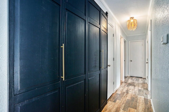 704 Vaughn Dr, Burleson, TX 76028 - corridor featuring ornamental molding, light wood-type flooring, and a textured wall