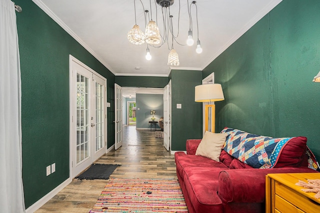 704 Vaughn Dr, Burleson, TX 76028 - living room with wood finished floors, a chandelier, crown molding, french doors, and baseboards