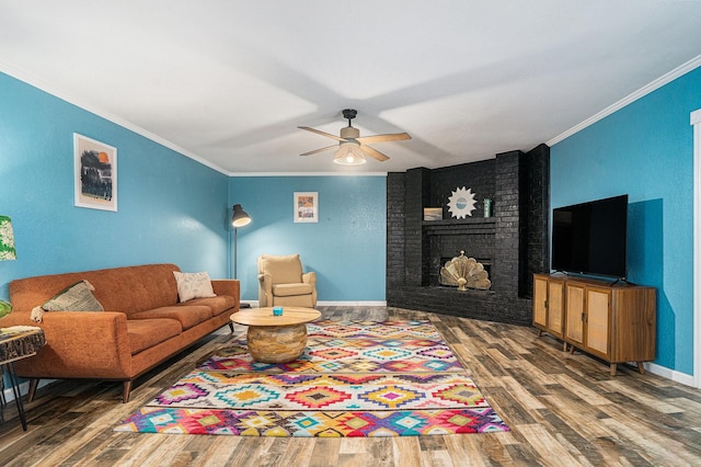 704 Vaughn Dr, Burleson, TX 76028 - living area with wood finished floors, crown molding, a ceiling fan, a fireplace, and baseboards