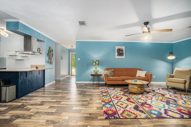 704 Vaughn Dr, Burleson, TX 76028 - living area featuring wood finished floors, crown molding, ceiling fan, and baseboards