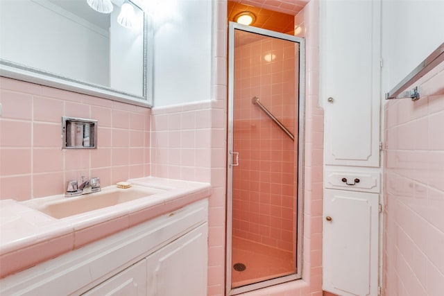 8639 Edgemere Rd Unit 1A, Dallas, TX 75225 - bathroom featuring tile walls, a stall shower, vanity, and backsplash