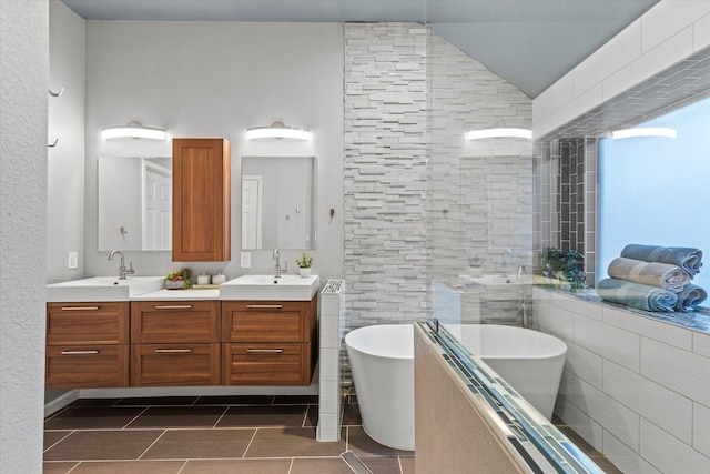 6436 Branchwood Trl, The Colony, TX 75056 - bathroom with tile patterned flooring, a soaking tub, double vanity, and lofted ceiling
