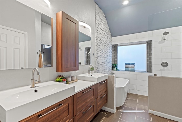 6436 Branchwood Trl, The Colony, TX 75056 - full bathroom with walk in shower, a soaking tub, double vanity, tile walls, and vaulted ceiling