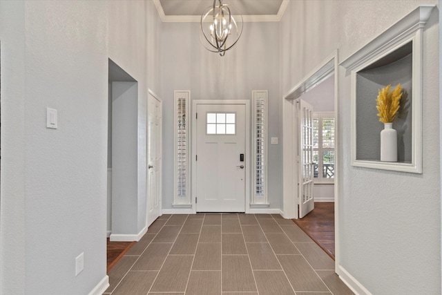 6436 Branchwood Trl, The Colony, TX 75056 - foyer entrance with a chandelier, a high ceiling, baseboards, and a textured wall