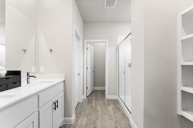 1225 Rolling Meadows Dr, Cedar Hill, TX 75104 - full bath featuring a stall shower, wood finished floors, double vanity, and baseboards