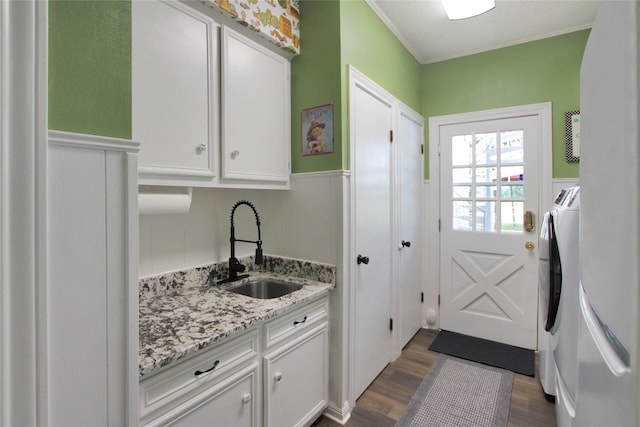 19413 US Highway 79 E, Jacksonville, TX 75766 - clothes washing area featuring washer and clothes dryer, dark wood-type flooring, cabinet space, a wainscoted wall, and ornamental molding