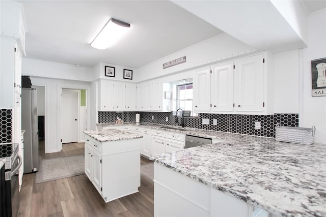 19413 US Highway 79 E, Jacksonville, TX 75766 - kitchen with a sink, dark wood finished floors, white cabinetry, light stone countertops, and backsplash
