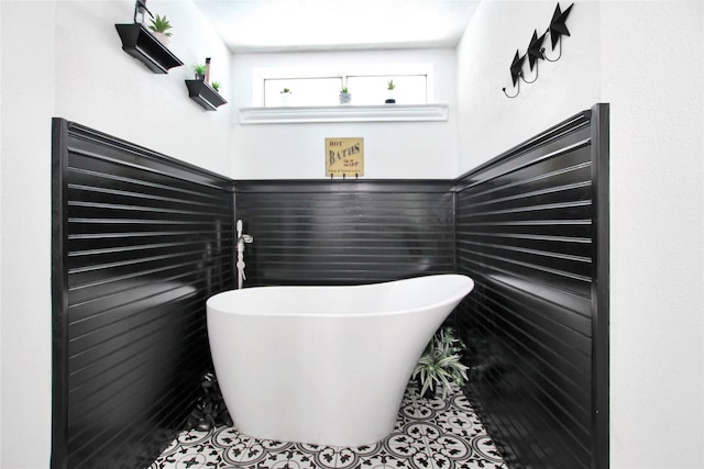 19413 US Highway 79 E, Jacksonville, TX 75766 - full bathroom with a freestanding bath and tile patterned floors