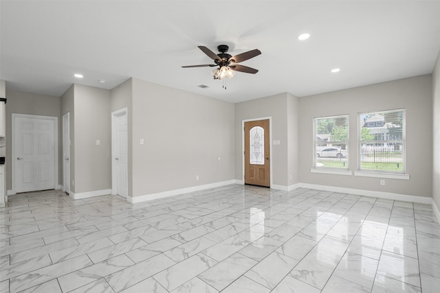 2636 Carter Ave, Fort Worth, TX 76103 - unfurnished living room featuring light marble finish floors, recessed lighting, a ceiling fan, and baseboards
