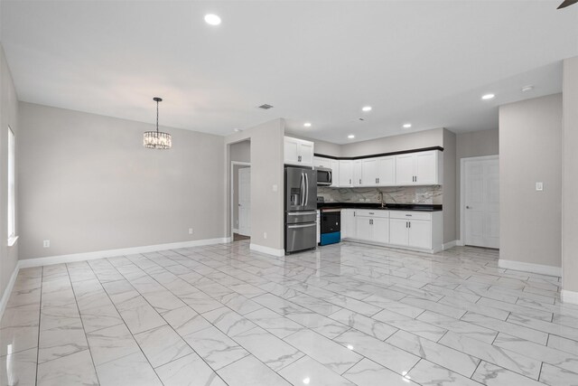 2636 Carter Ave, Fort Worth, TX 76103 - kitchen with appliances with stainless steel finishes, open floor plan, dark countertops, light marble finish floors, and recessed lighting
