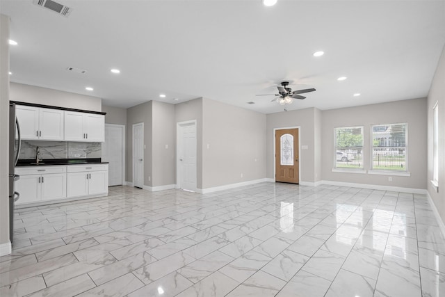 2636 Carter Ave, Fort Worth, TX 76103 - unfurnished living room with ceiling fan, recessed lighting, baseboards, and light marble finish floors