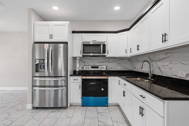 2636 Carter Ave, Fort Worth, TX 76103 - kitchen featuring stainless steel appliances, a sink, light marble finish floors, recessed lighting, and white cabinetry